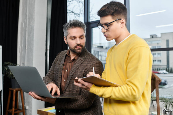 Two colleagues interact during onboarding in a stylish office, sharing insights on the first day.