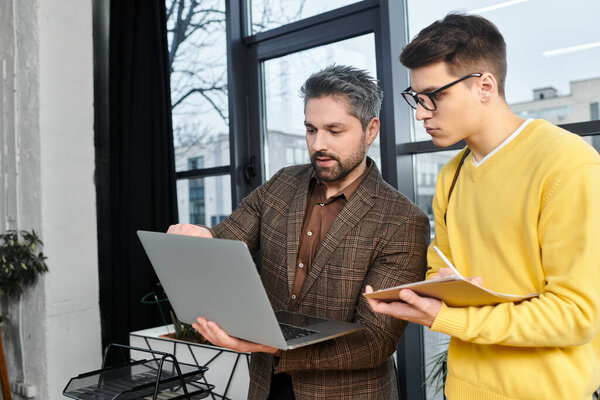 A new employee is receiving guidance from a mentor while starting their first day at work.