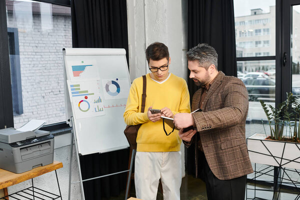Two professionals discuss details while onboarding in a stylish office environment.