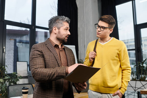 Two colleagues engaging in conversation while navigating the onboarding process in an office.
