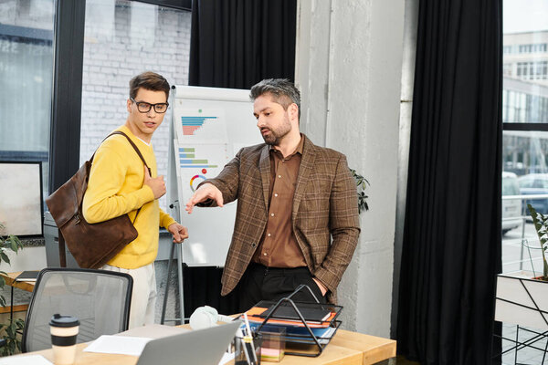 New employee receives guidance and tips from a mentor in a bright, contemporary office space.