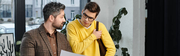 New employee receives orientation while chatting and engaging with a friendly colleague.