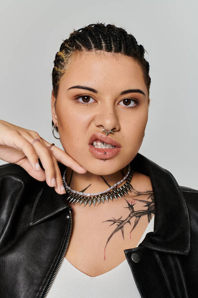 Confident young woman displays her unique style with trendy accessories and bold expression.