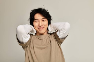 Havalı genç adam havalı kişiliğini basit bir arka planda ifade eder, gençlik enerjisi yayar..