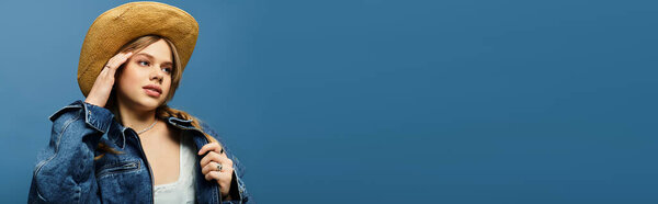 A young woman showcases her trendy denim jacket while enjoying the spring atmosphere in a studio, banner
