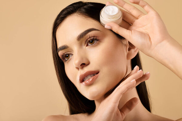 Young woman demonstrates skincare routine, highlighting her healthy and luminous complexion.
