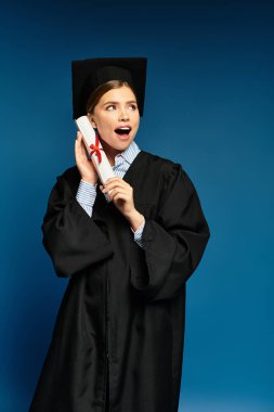 Genç bir kadın mezuniyet elbisesiyle sevinçle diplomasını tutuyor ve bir dönüm noktasını kutluyor..