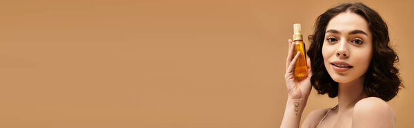 A young woman demonstrates her beauty skincare routine while smiling, showcasing her glowy skin, banner