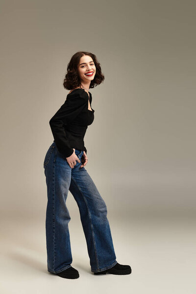 A cheerful young woman showcases her stylish braces and bold red lips while posing confidently.