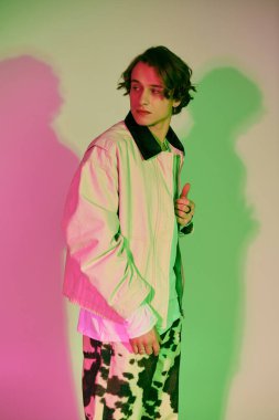 Genç ve yakışıklı bir adam olarak gençlik kültürünün dinamik keşfi modaya uygun giysiler içinde durmaktadır.