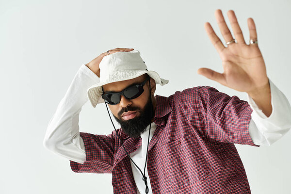 Confident young man expresses individuality with trendy attire and unique accessories indoors