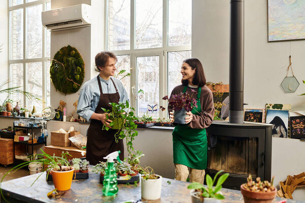 Creative couple engage joyfully, nurturing plants and sharing ideas in a vibrant art studio setting