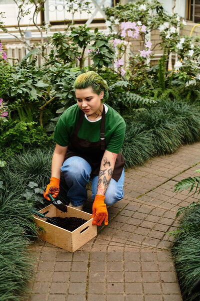 A dedicated young woman passionately nurtures plants in a greenhouse.