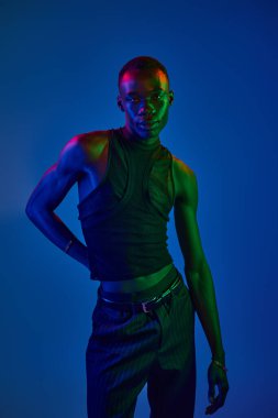 Genç bir Afro-Amerikan erkeği tarzını parlak renklere karşı sergiliyor, modern modanın vücut bulmuş hali..