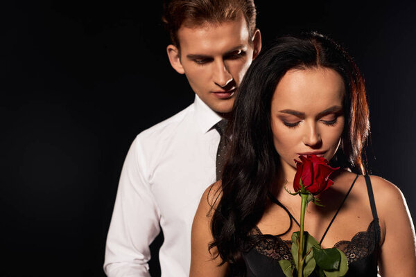 This couple shares a romantic moment, showcasing their love in soft candlelight.