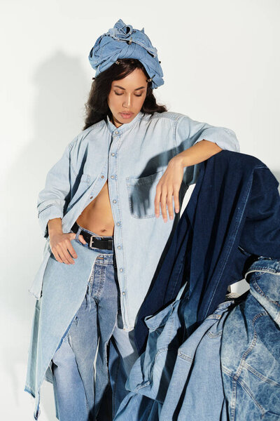 A beautiful young woman elegantly showcases a modern denim style, emphasizing summer fashion.