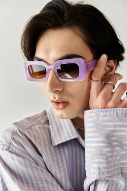 Şık, ikili olmayan bir birey, canlı renk ve desenleri kucaklayarak kendine güvenerek poz verir..