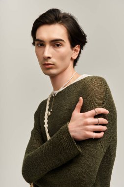 Genç insan, şık kıyafetler ve sessiz tonlarda düşünceli duruşu olan ikili bir kimliğe sahip değil..