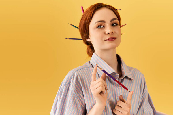 A young woman playfully showcases colorful pencils in her hair, radiating creativity.