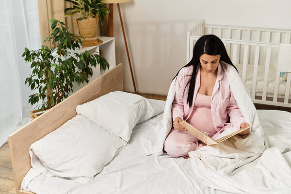 Young woman sits comfortably on bed, reading with joy and anticipation in a serene room.