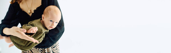 A young mother joyfully interacts with her little child, showcasing love and warmth.