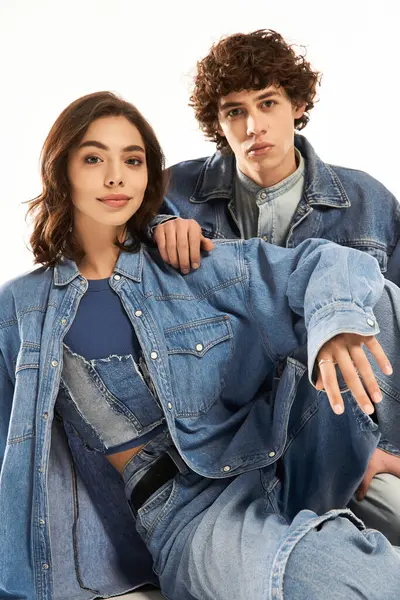 Son moda genç çift birlikte poz veriyor, aşk ve moda eşgüdümlü kot giysiler giyiyorlar..