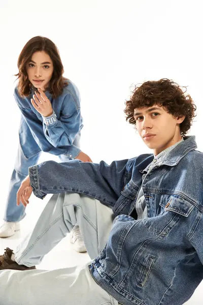 Canlı bir stüdyoda, şık bir çift, kot kıyafetleri içinde neşeli bir şekilde poz verirken aşk yayar..