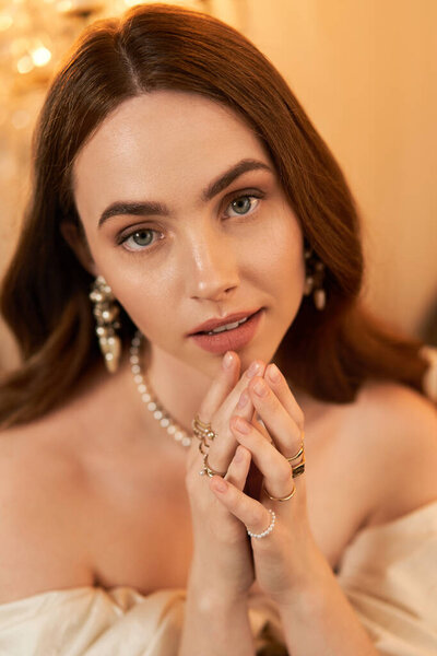 Radiating elegance, a young woman poses in a vintage dress with delicate accessories.