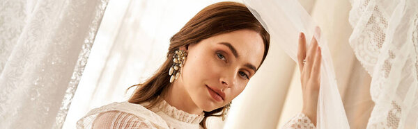 A beautiful young woman in a vintage dress stands gracefully by lace curtains, exuding charm, banner