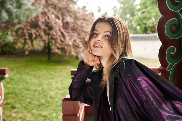 A lovely young woman poses in a traditional korean hanok gazego.
