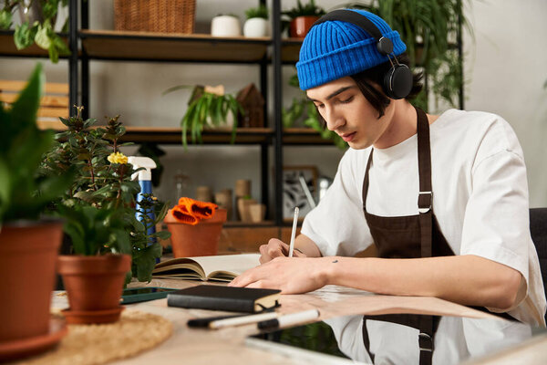 Handsome young man meticulously transplanting plants and tending to his creative workspace.