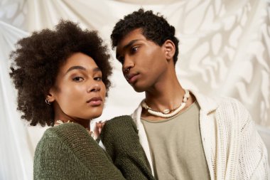 Romantik bir çift, yumuşak ve basit bir arkaplana karşı samimi bir anı paylaşıyor..