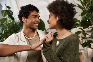 Genç çift, samimi ortamlarının sıcaklığının tadını çıkarırken sevgi dolu bakışlar atıyorlar..