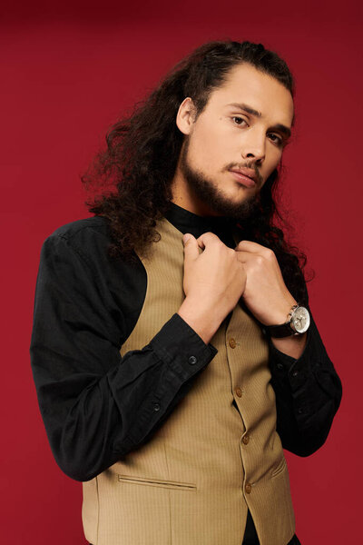 Confident young man with a beard showcases his style in a trendy vest, exuding charm and charisma.