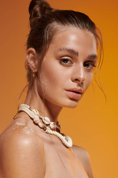 A young woman with tan skin showcases summer fashion in a vibrant studio setting.