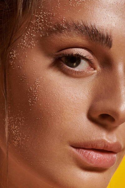 Young woman poses confidently in summer studio environment.