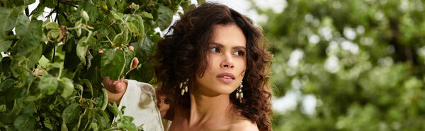 Amidst the lush greenery, a beautiful young woman poses gracefully in garden, banner