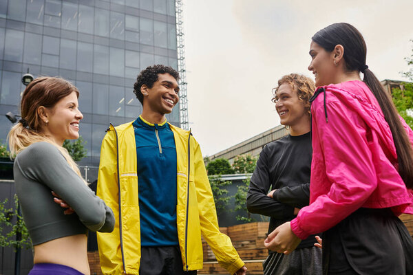 Four vibrant young individuals share moments of joy and connection in an outdoor setting.