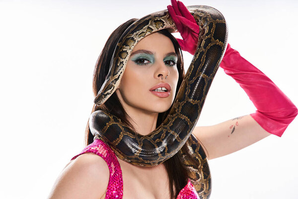 A captivating young woman exudes elegance and danger in her stunning outfit with a snake.