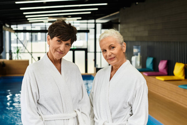 Two lovely mature women enjoy a joyful moment at a wellness center.