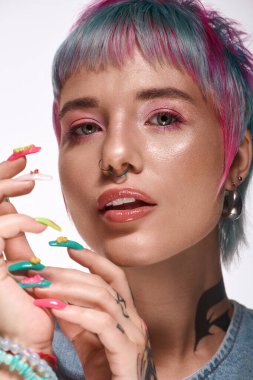 Renkli kısa saçlı genç bir kadın kendine güvenerek, eşsiz stilini ve güzelliğini ifade ediyor..