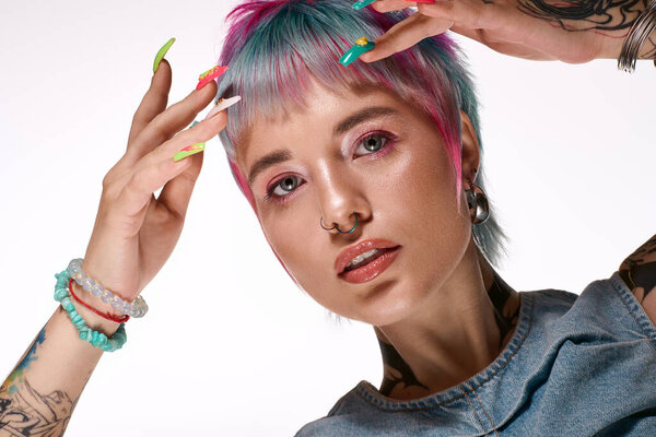 Молодая женщина с короткими, красочными волосами демонстрирует свой уникальный стиль в творческой студии.
