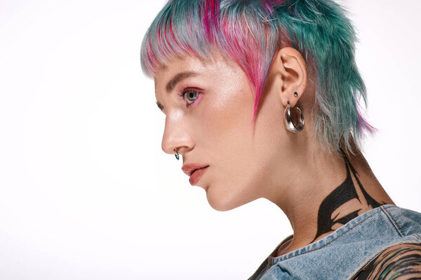 A young woman with colorful short hair showcases her unique style in a bright studio.