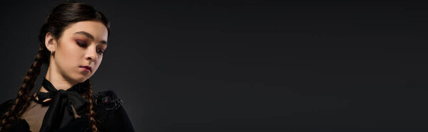 A girl in braids dons a gothic dress, channeling the essence of Halloween and Wednesday, banner