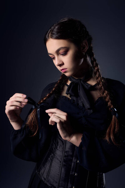 A girl dressed in a gothic style Halloween costume captures the essence of October.