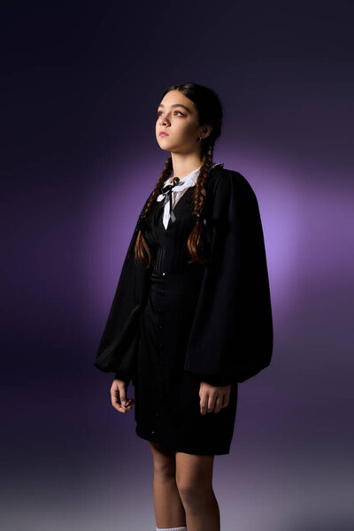 A girl with braids stands confidently, embracing her Halloween spirit in a gothic Wednesday dress.