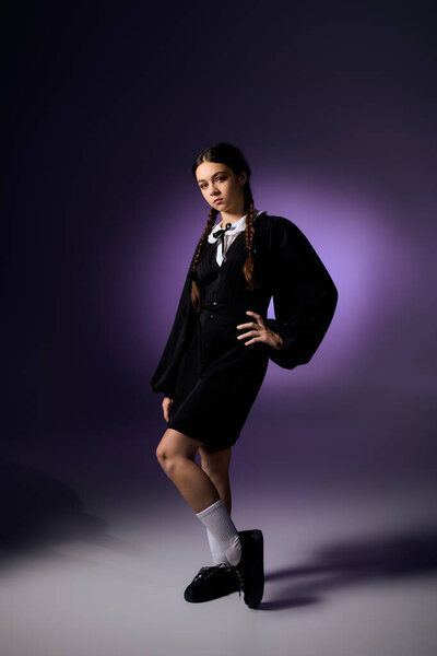 A girl in braids wears a gothic Wednesday dress that captures the Halloween spirit.