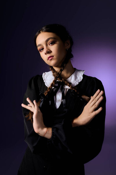 A girl in gothic style captures Halloween spirit as a Wednesday character