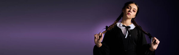 A girl with braids dressed in a gothic style Wednesday costume enjoys a spooky moment, banner