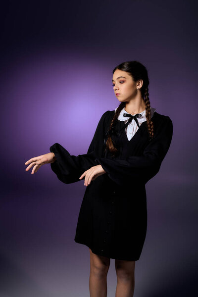 A child with braids wears a gothic-themed dress, portraying Wednesday for Halloween festivities.